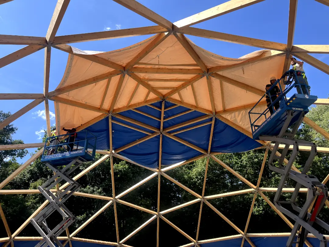 View up at the frame with the first white and blue panels of the dome skin in place